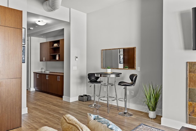 interior space featuring baseboards and wood finished floors