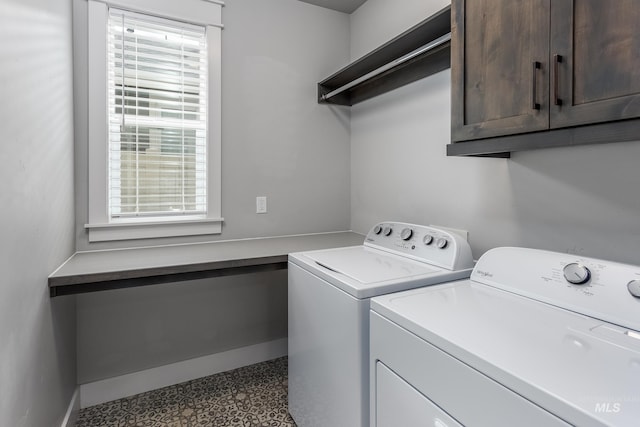 laundry room featuring cabinet space, separate washer and dryer, healthy amount of natural light, and baseboards