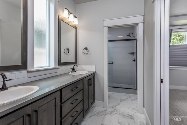 full bathroom featuring marble look tiles, baseboards, a stall shower, tasteful backsplash, and double vanity