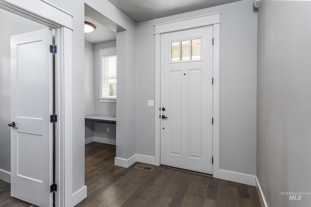 entryway featuring dark wood-style floors and baseboards