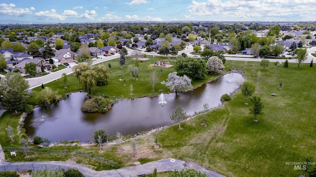 aerial view of property's location featuring a large body of water and nearby suburban area