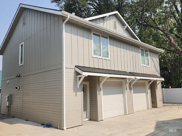 504 S Utah, Fruitland, ID 83619 - view of side of home featuring a garage, driveway, and board and batten siding