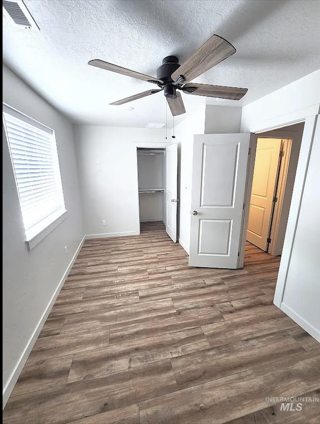 504 S Utah, Fruitland, ID 83619 - unfurnished bedroom featuring a textured ceiling, wood finished floors, a closet, and ceiling fan
