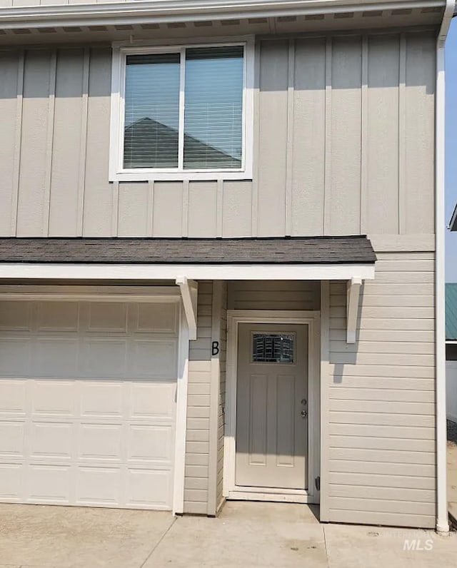 504 S Utah, Fruitland, ID 83619 - doorway to property with board and batten siding and an attached garage