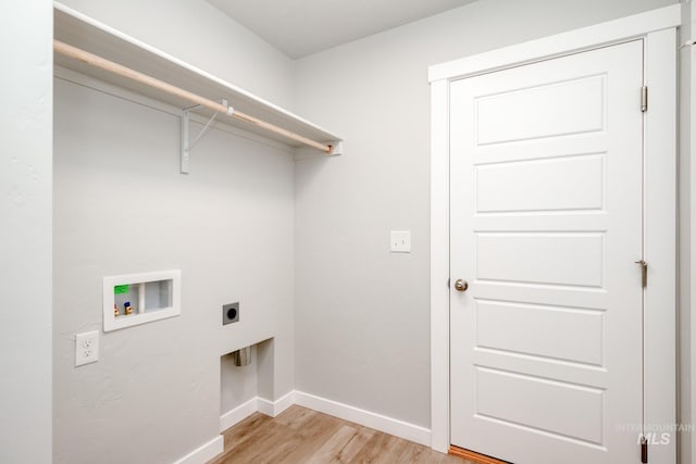 clothes washing area featuring laundry area, hookup for an electric dryer, baseboards, hookup for a washing machine, and light wood-style floors