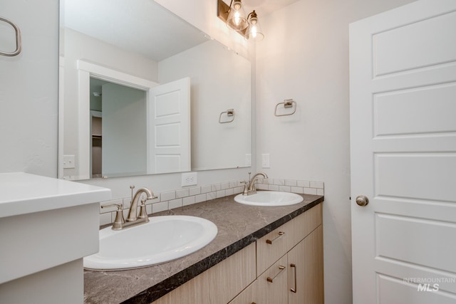 bathroom with a sink and double vanity