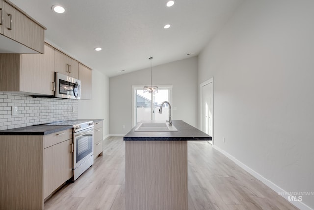 kitchen with a sink, stainless steel microwave, lofted ceiling, tasteful backsplash, and range with electric stovetop