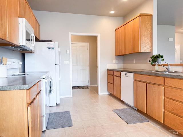 1937 E Vandal Dr, Moscow, ID 83843 - kitchen with white appliances, a sink, baseboards, dark countertops, and recessed lighting