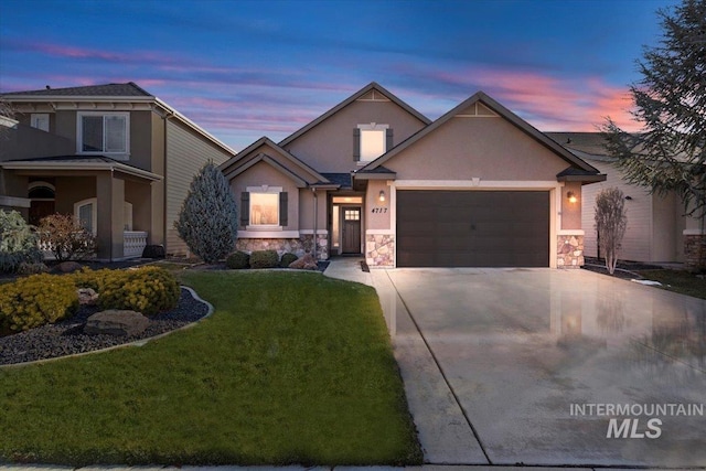 view of front facade with a garage and a lawn