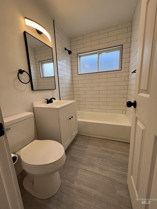 317 Baker Dr, Mountain Home, ID 83647 - full bath featuring vanity, bathing tub / shower combination, toilet, and a textured wall