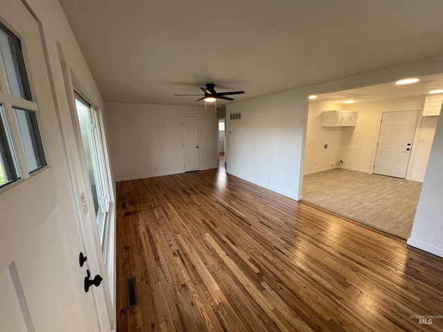 317 Baker Dr, Mountain Home, ID 83647 - unfurnished living room with hardwood / wood-style floors, ceiling fan, and baseboards
