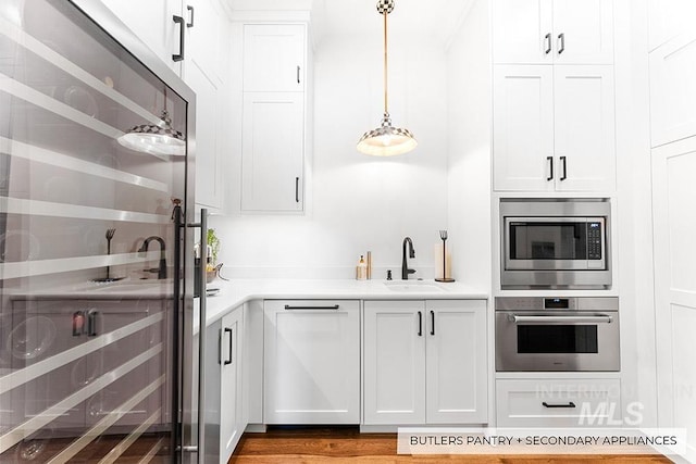 kitchen with white cabinetry, appliances with stainless steel finishes, light countertops, and a sink