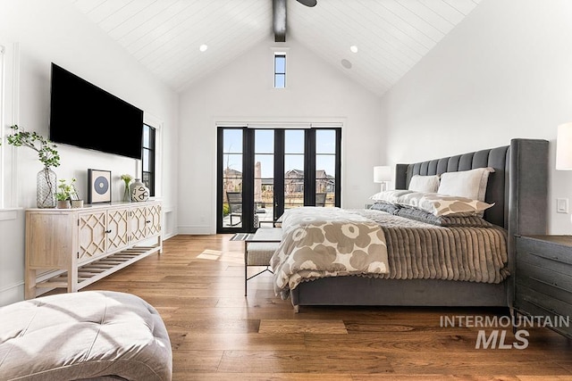 bedroom with french doors, hardwood / wood-style floors, high vaulted ceiling, access to outside, and baseboards