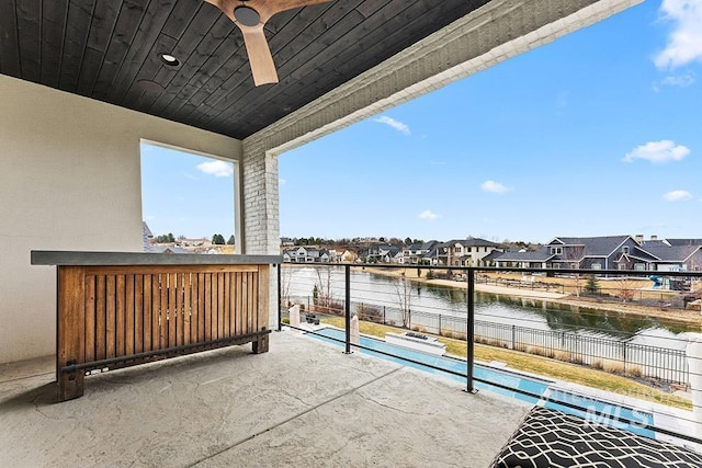 balcony with a residential view and a water view