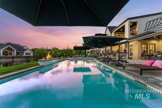 view of pool with a fenced in pool, a patio area, and fence