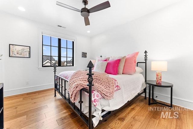 bedroom featuring light wood finished floors, baseboards, visible vents, and recessed lighting