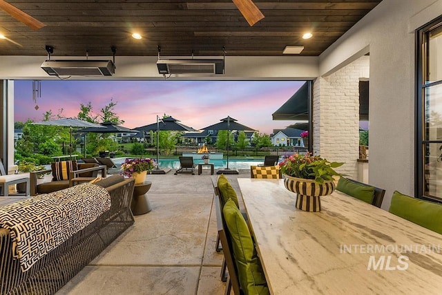 view of patio / terrace with ceiling fan, outdoor dining area, and an outdoor pool