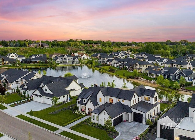 birds eye view of property with a water view and a residential view