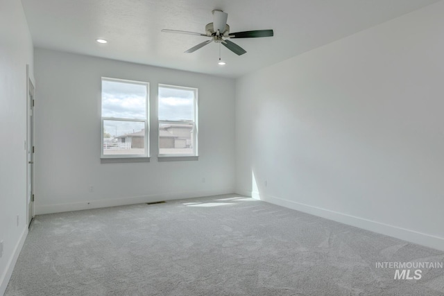 carpeted empty room featuring ceiling fan