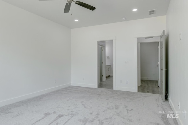 unfurnished bedroom with ceiling fan and light carpet