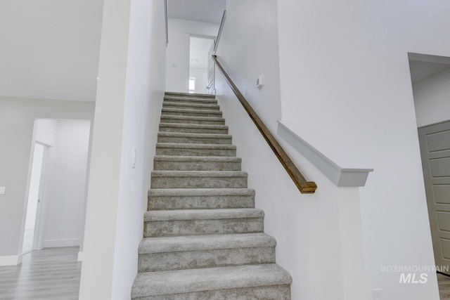 staircase featuring hardwood / wood-style floors