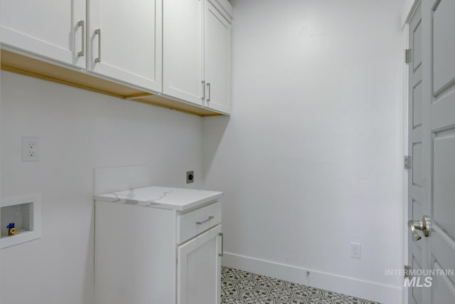 washroom with cabinets, hookup for a washing machine, and hookup for an electric dryer