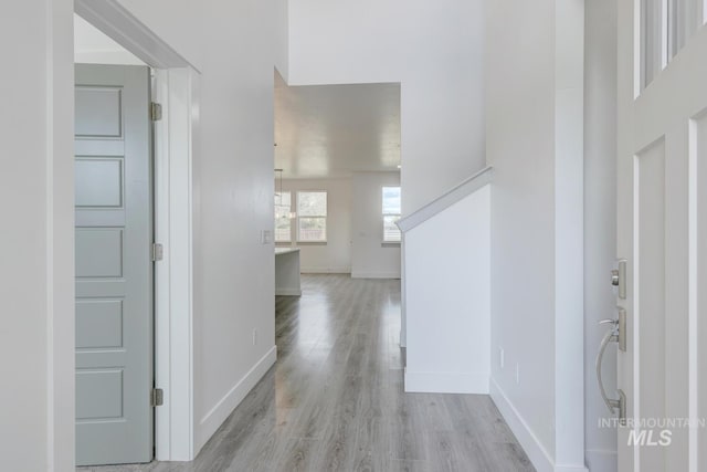 hallway with light hardwood / wood-style floors