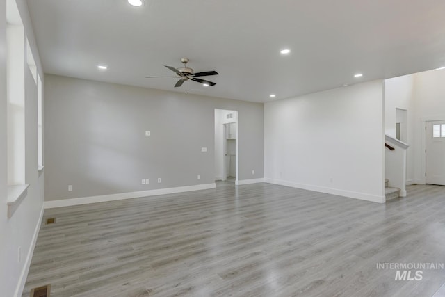 empty room with light wood-type flooring and ceiling fan