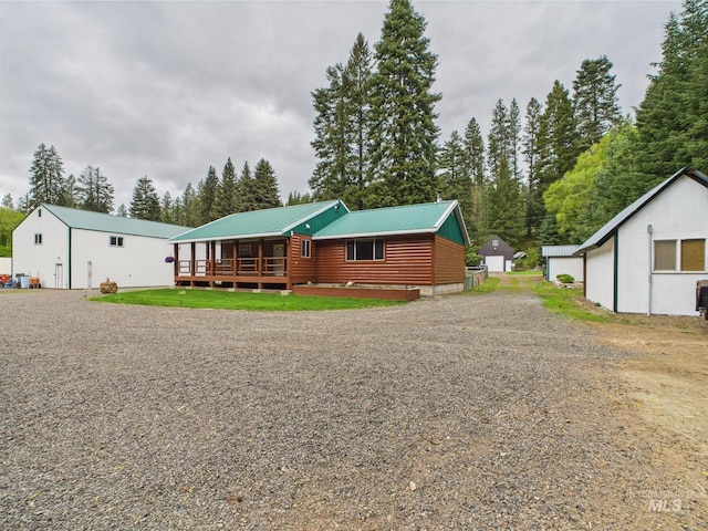 4474 Council Cuprum Rd, Council, ID 83612 - view of front facade with a deck, log veneer siding, metal roof, and driveway