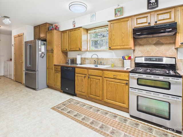 4474 Council Cuprum Rd, Council, ID 83612 - kitchen with stainless steel appliances, under cabinet range hood, a sink, washer and clothes dryer, and tasteful backsplash