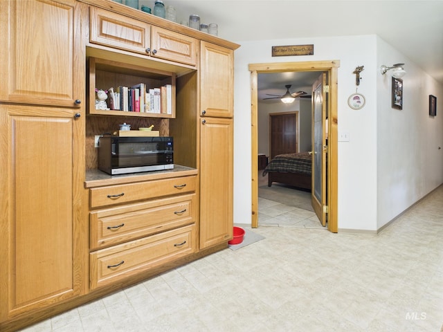 4474 Council Cuprum Rd, Council, ID 83612 - kitchen featuring stainless steel microwave, ceiling fan, light floors, and baseboards
