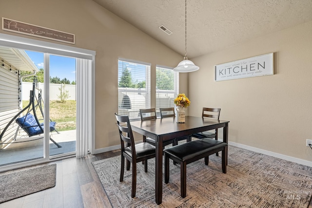 16848 Loggia Ave, Caldwell, ID 83607 - dining space with vaulted ceiling, wood finished floors, a textured ceiling, and baseboards