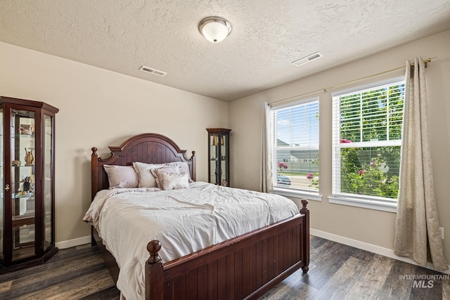 16848 Loggia Ave, Caldwell, ID 83607 - bedroom with baseboards, a textured ceiling, and dark wood-style flooring