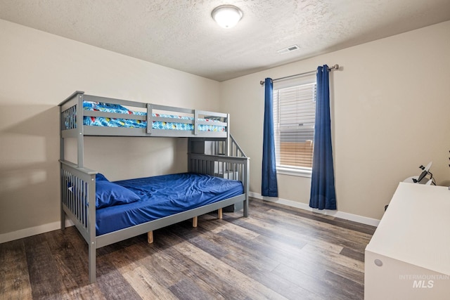 16848 Loggia Ave, Caldwell, ID 83607 - bedroom with wood finished floors, baseboards, and a textured ceiling