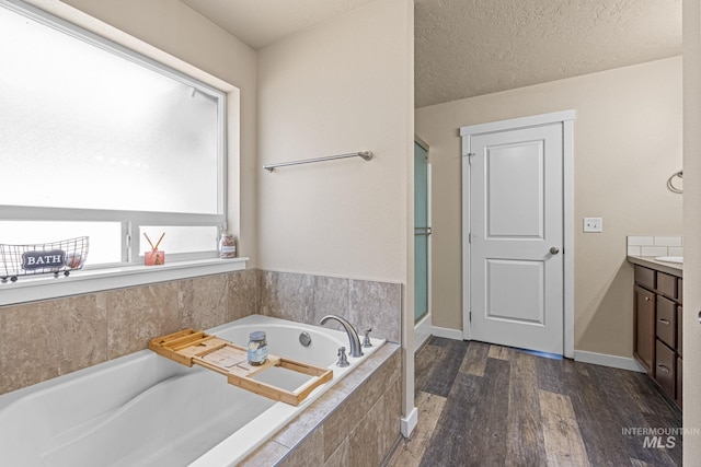 16848 Loggia Ave, Caldwell, ID 83607 - full bath featuring vanity, a bath, wood finished floors, and a shower stall