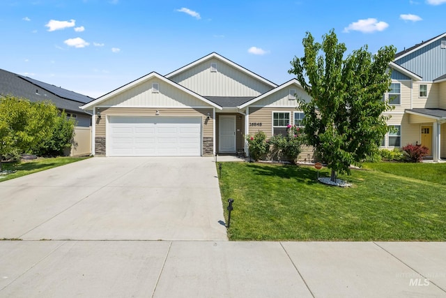 16848 Loggia Ave, Caldwell, ID 83607 - view of front of house featuring a garage, driveway, a front lawn, stone siding, and board and batten siding
