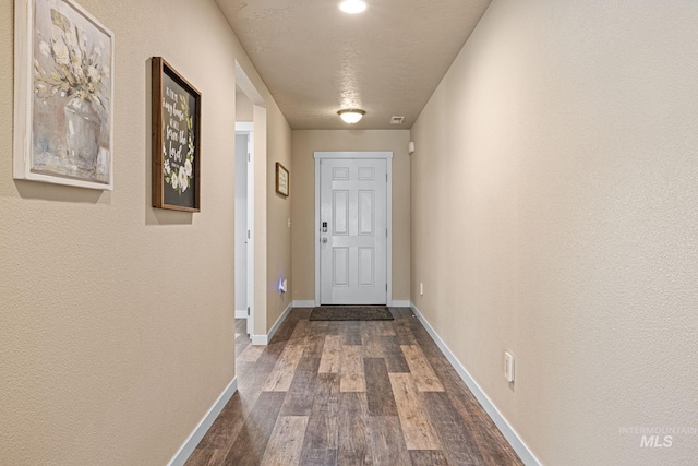 16848 Loggia Ave, Caldwell, ID 83607 - doorway with dark wood-type flooring and baseboards