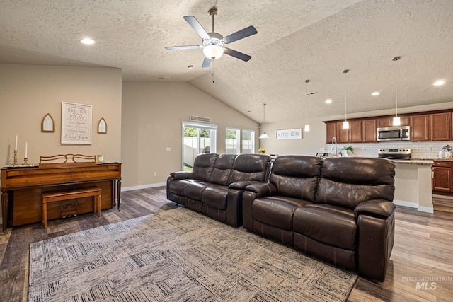 16848 Loggia Ave, Caldwell, ID 83607 - living room featuring a textured ceiling, wood finished floors, a ceiling fan, vaulted ceiling, and baseboards