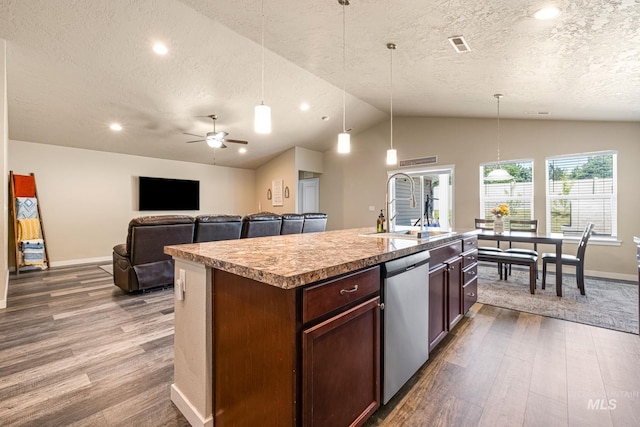 16848 Loggia Ave, Caldwell, ID 83607 - kitchen with dishwasher, a sink, wood finished floors, a textured ceiling, and vaulted ceiling