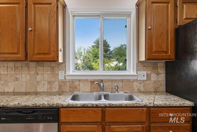646 W Falls Ave, Twin Falls, ID 83301 - kitchen with stainless steel dishwasher, light countertops, backsplash, and brown cabinetry