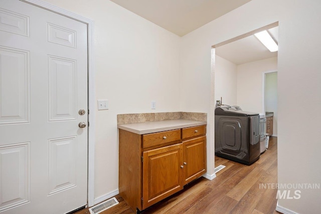 646 W Falls Ave, Twin Falls, ID 83301 - laundry room with washer / dryer and light wood-type flooring