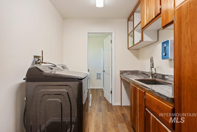 646 W Falls Ave, Twin Falls, ID 83301 - washroom with dark wood-style floors, washing machine and dryer, and cabinet space