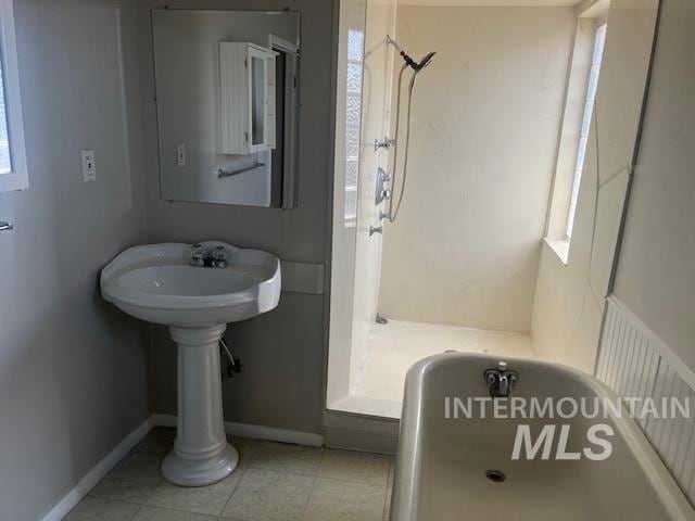 bathroom featuring radiator heating unit, tile patterned floors, and a bathtub