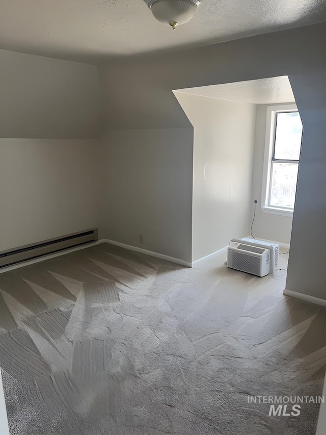 bonus room featuring a wall mounted AC, baseboard heating, carpet, vaulted ceiling, and a textured ceiling