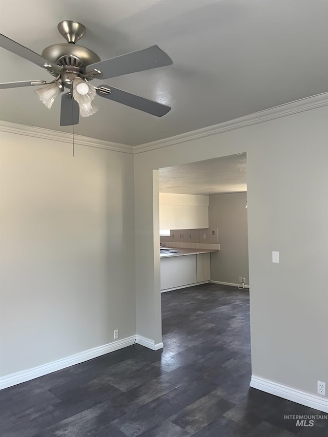 unfurnished room featuring dark wood-type flooring, ceiling fan, and ornamental molding