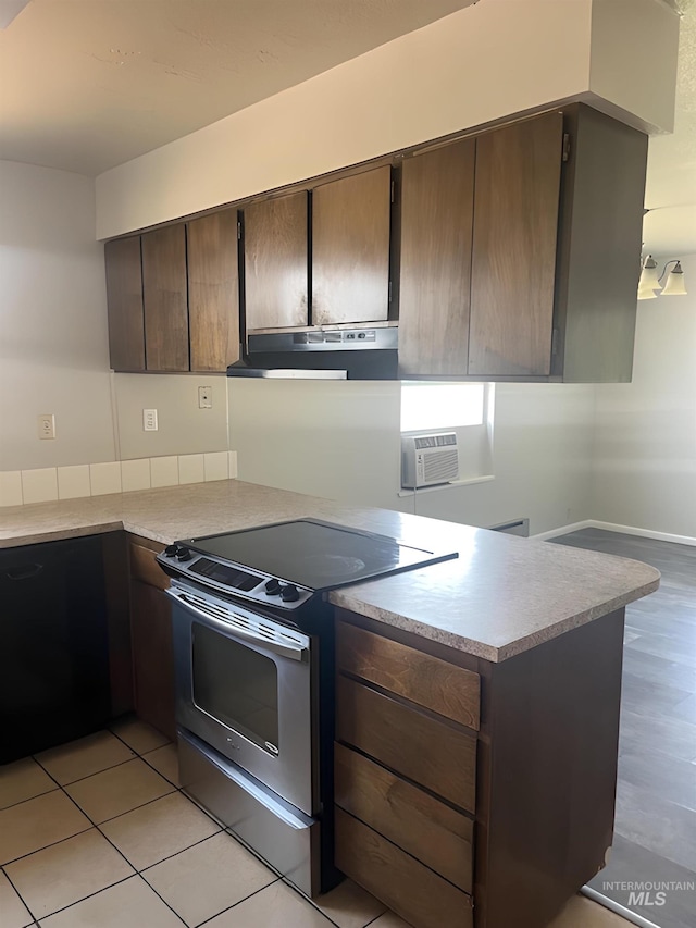 kitchen with stainless steel electric stove, kitchen peninsula, light hardwood / wood-style floors, dark brown cabinetry, and ventilation hood