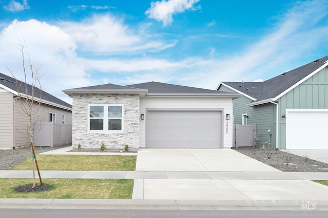 2386 N Leatherwood Ave, Star, ID 83669 - view of front of home with a garage, stone siding, and driveway