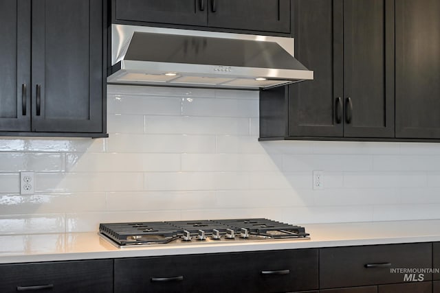 2386 N Leatherwood Ave, Star, ID 83669 - kitchen with under cabinet range hood, light countertops, tasteful backsplash, and stainless steel gas cooktop