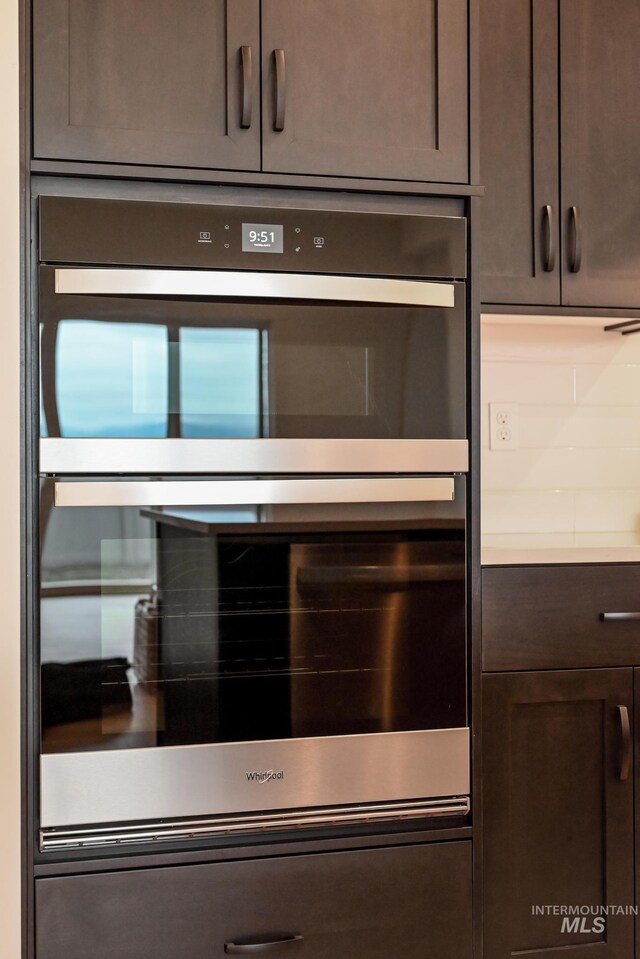 2386 N Leatherwood Ave, Star, ID 83669 - kitchen view of dark brown cabinets, stainless steel double oven, and light countertops