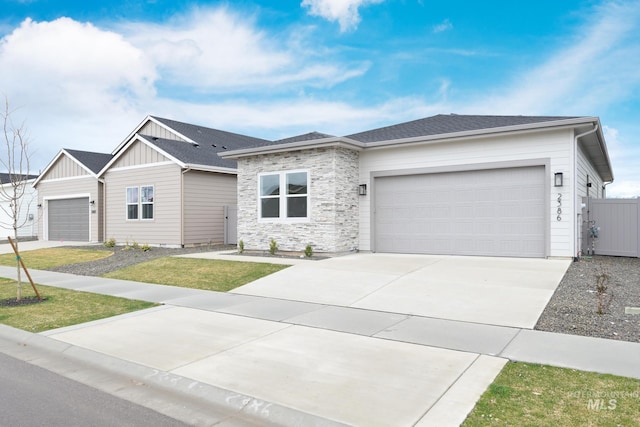 2386 N Leatherwood Ave, Star, ID 83669 - view of front of home with board and batten siding, a garage, driveway, and stone siding